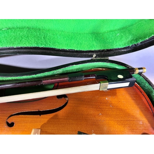 1522 - A Parrot Violin, made in China, and bow with a hard carry case, 55cm max and 35cm back.