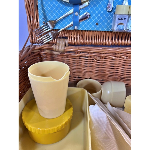 1527 - A 1950’s Sirram picnic basket with yellow plastic plates, sandwich boxes, cups, condiments etc (not ... 