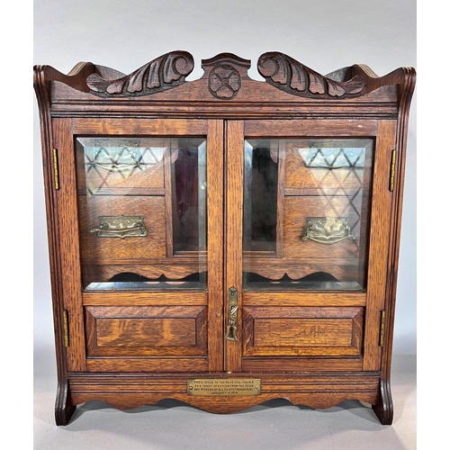 1528 - An Edwardian oak smoker’s cabinet with a fitted interior of drawers and pipe rack, 41cm wide.