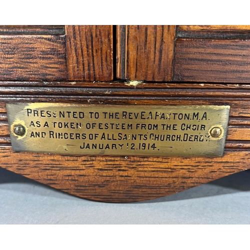 1528 - An Edwardian oak smoker’s cabinet with a fitted interior of drawers and pipe rack, 41cm wide.