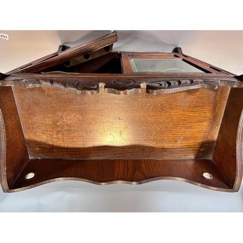 1528 - An Edwardian oak smoker’s cabinet with a fitted interior of drawers and pipe rack, 41cm wide.