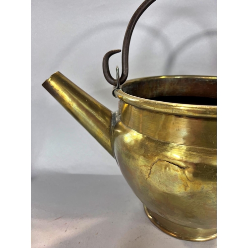 1529 - A 19th century brass cooking pot with an iron loop handle and a later added pouring spout, an early ... 