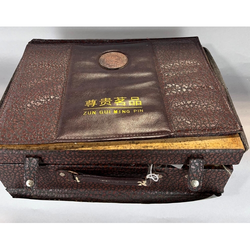 1530 - A Chinese clay tea service set in a briefcase, and a Chinese silk liners storage box.