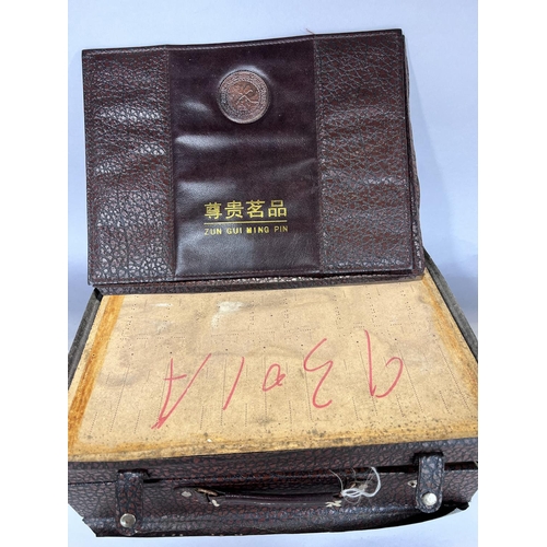 1530 - A Chinese clay tea service set in a briefcase, and a Chinese silk liners storage box.