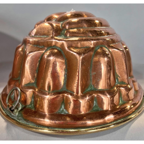 1550 - Two 19th century copper jelly and aspic moulds, a copper mixing bowl and a copper double handled pan... 