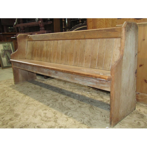 2288 - A Victorian pitch pine church pew, with chamfered ends, plank seat and tongue and groove boarded bac... 