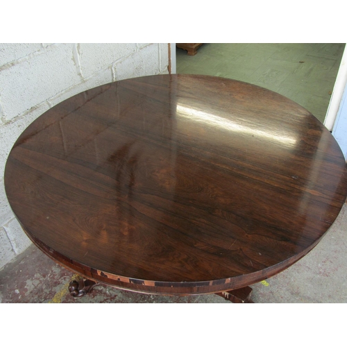 2466 - A Victorian rosewood tea table, the circular top on turned and tapered pillar tricorn base, 122 cm d... 