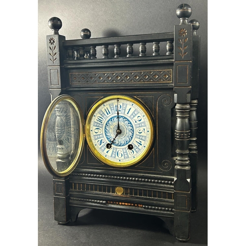 1363 - A Victorian mantle clock in the aesthetic style, the ebonised case with geometric detail and gilt hi... 