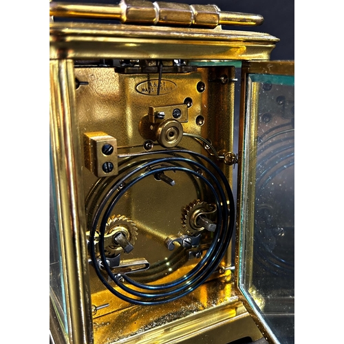 1367 - A late 19th century French carriage clock with enamelled dial and eight day striking movement, with ... 