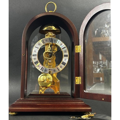 1370 - A contemporary skeleton clock, in an arched mahogany coloured and brass inlaid case