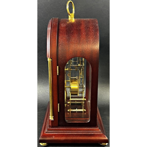 1370 - A contemporary skeleton clock, in an arched mahogany coloured and brass inlaid case