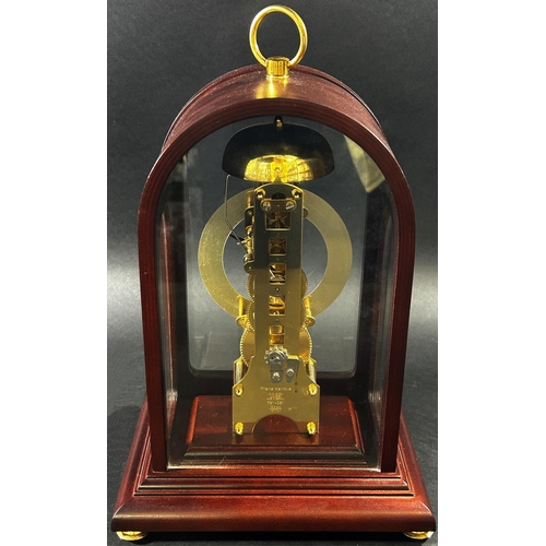 1370 - A contemporary skeleton clock, in an arched mahogany coloured and brass inlaid case