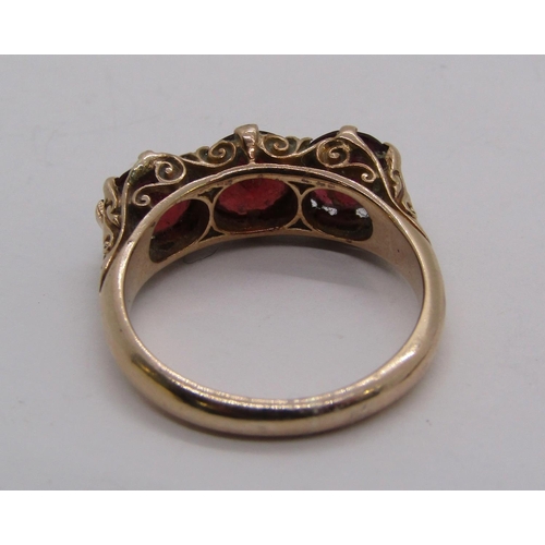 1307 - 9ct garnet three stone ring, size O/P, together with two pairs of 9ct creole type earrings, 6.5g tot... 