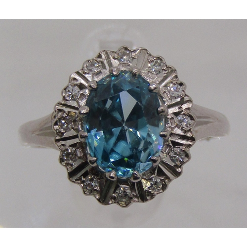 1310 - 18ct white gold blue zircon and diamond oval cluster ring, size M, 4.3g