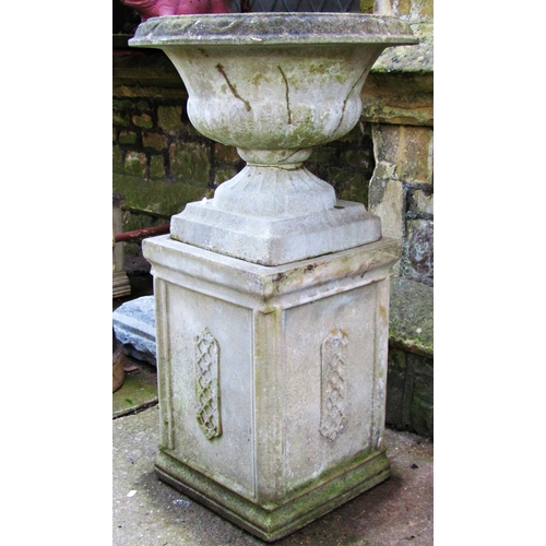 2026 - A weathered cast composition stone garden urn, the squat circular lobed bowl with flared rim, fixed ... 