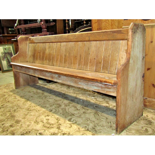 2288 - A Victorian pitch pine church pew, with chamfered ends, plank seat and tongue and groove boarded bac... 