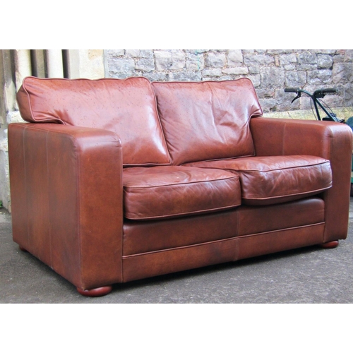 2308 - A contemporary stitched tan leather upholstered two seat club sofa, with loose seat and back cushion... 