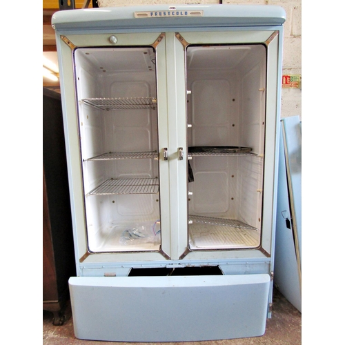 2493 - A Prestcold vintage two divisional refrigerator in a pale blue colourway enclosed by two doors with ... 