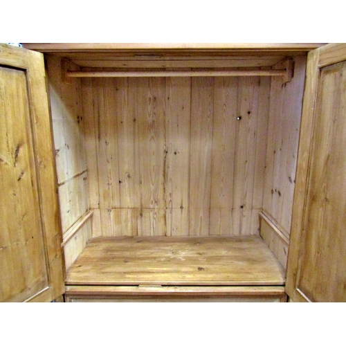 2541 - A waxed hanging cupboard, the lower section enclosed by three frieze drawers, the upper section by t... 