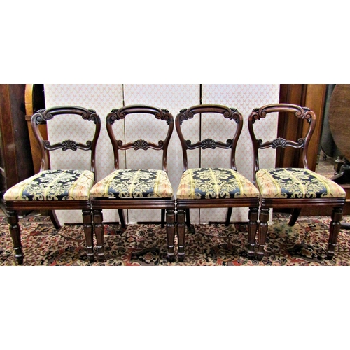 2566 - A set of four Regency rosewood dining chairs with carved and moulded frames, the splats with anthemi... 