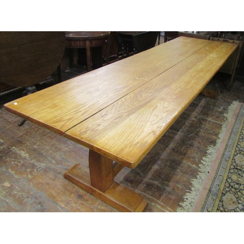 2593 - An oak refectory table, the heavy plank top raised on a simple stretcher base united by a central ra... 