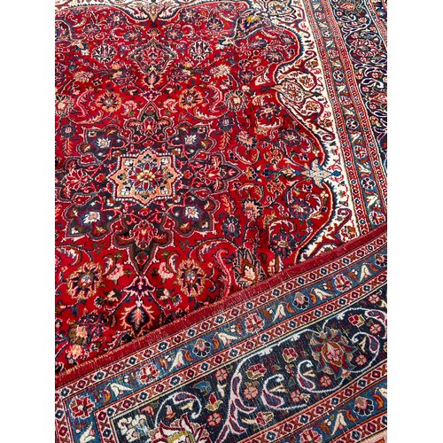 1657 - A large Country House Persian design carpet with a central medallion and an all over floral pattern ... 