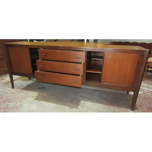 2440 - A good quality mid-20th century teak wood sideboard, three central drawers flanked by two tambour ca... 