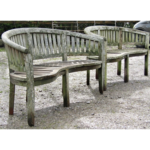 1 - A pair of weathered teak banana shaped garden benches (af) 158 cm wide