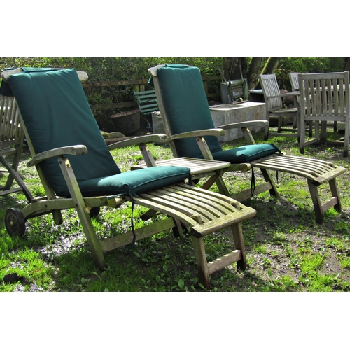 4 - A pair of good quality weathered teak folding steamer type garden lounge chairs labelled 'Teak Tiger... 