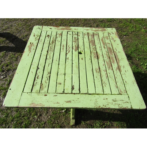 40 - An Arts & Crafts style light green painted and weathered teak garden table, the square slatted panel... 