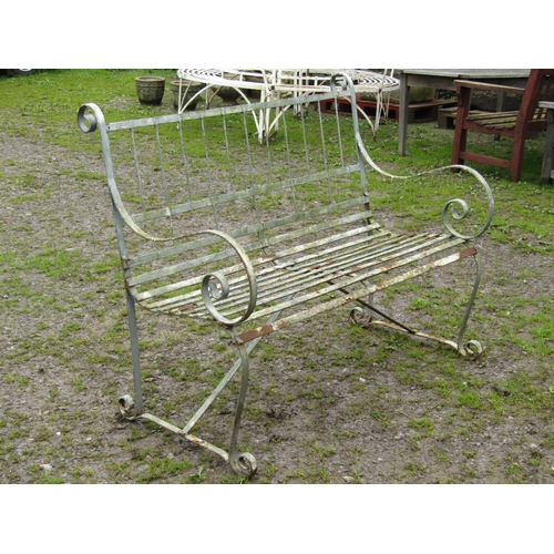 10 - A weathered sprung steel two seat garden bench with strap work seat and scroll detail, 122 cm (4ft w... 