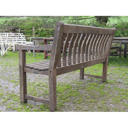 12 - A weathered teak garden bench with slatted seat and back with curved splats (af) 148 cm wide