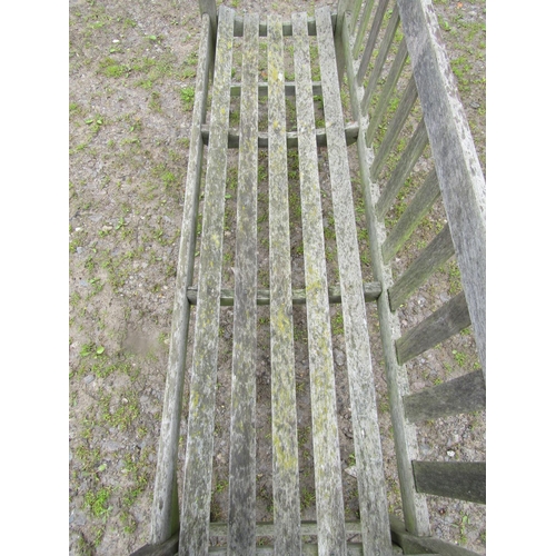 31 - A vintage weathered teak three seat garden bench with slatted seat and back, probably a Lister examp... 