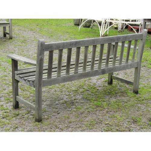 31 - A vintage weathered teak three seat garden bench with slatted seat and back, probably a Lister examp... 