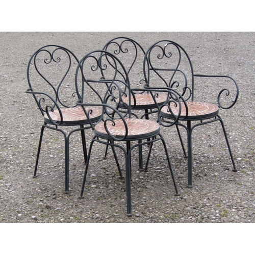 44 - A set of four heavy gauge painted steel garden open armchairs with S shaped scroll detail and circul... 
