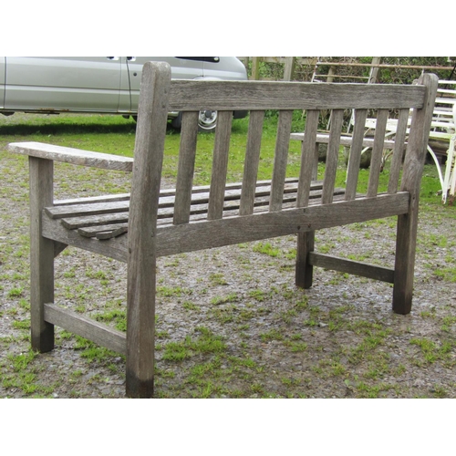 9 - A weathered two seat garden bench with slatted seat and back, 128 cm wide (af)