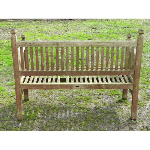 39 - A vintage Arts & Crafts style weathered teak two seat garden bench with slender slatted seat and bac... 