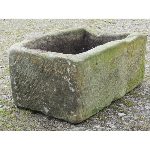 100 - A weathered bowfronted rectangular natural stone trough, 73cm wide x 57cm deep x 32cm high