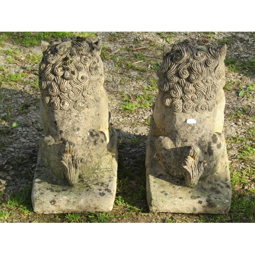 107 - A collection of weathered mainly cast composition stone Far Eastern garden ornaments comprising a pa... 