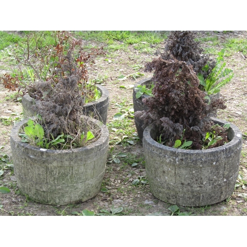 109 - A set of four weathered cast composition stone garden planters in the form of coopered half barrels,... 