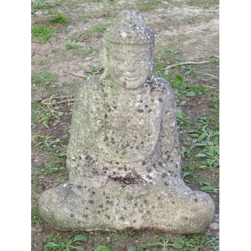 110 - A nicely weathered cast composition stone garden ornament in the form of a seated cross legged buddh... 