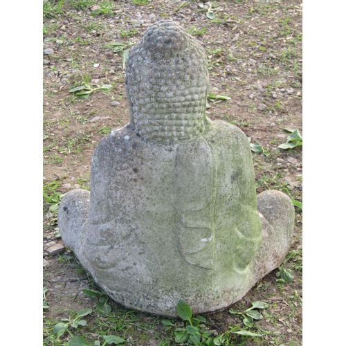 110 - A nicely weathered cast composition stone garden ornament in the form of a seated cross legged buddh... 