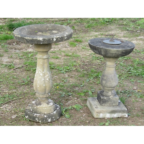 114 - A weathered cast composition stone three sectional bird bath with circular top raised on a tulip ped... 