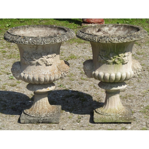 115 - A pair of nicely weathered cast composition stone Campana shaped garden urns, with flared egg and da... 