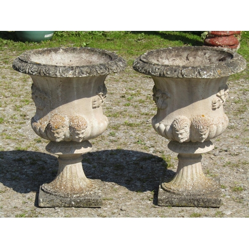 115 - A pair of nicely weathered cast composition stone Campana shaped garden urns, with flared egg and da... 