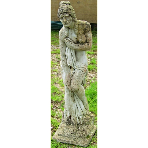 121 - A weathered cast composition stone garden ornament in the form of a scantily clad maiden 94 cm high,... 