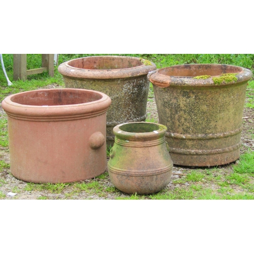 124 - A pair of weathered terracotta planters of circular tapered form with moulded rims, ribbed and incis... 