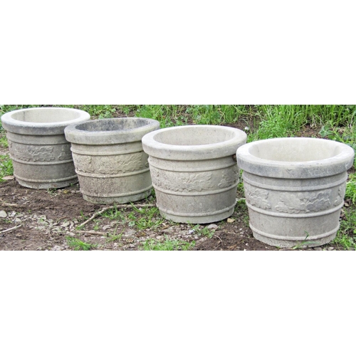 131 - A set of four weathered circular tapered planters with repeating acorn and oak leaf and banded detai... 