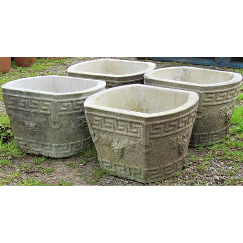 132 - A set of four weathered composition stone planters with Greek key and fruiting grape vine detail, 38... 