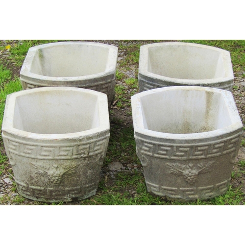 132 - A set of four weathered composition stone planters with Greek key and fruiting grape vine detail, 38... 